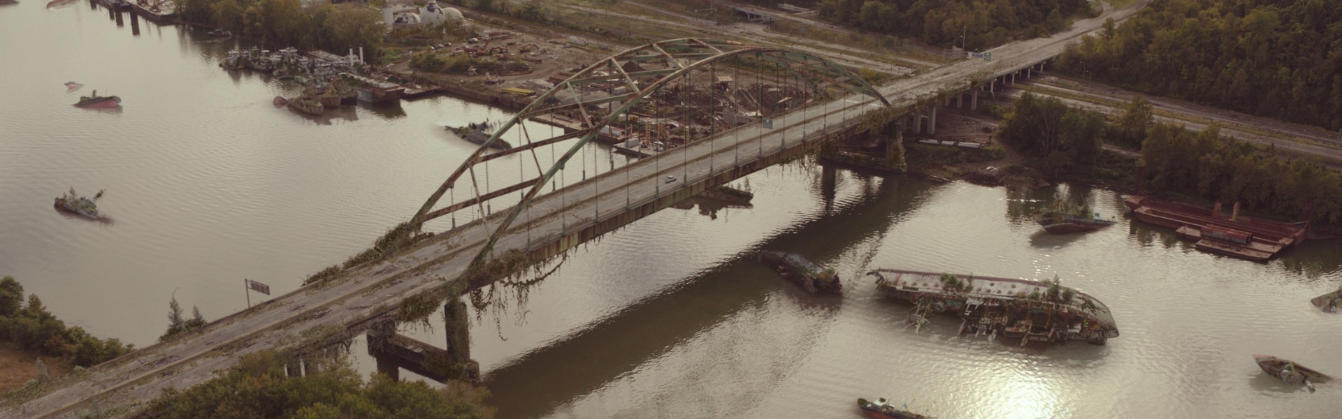 decaying bridge in post-apocalyptic world from 'The Last of Us'