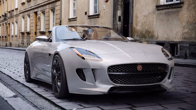 Photorealistic silver sports car on a cobbled city street.